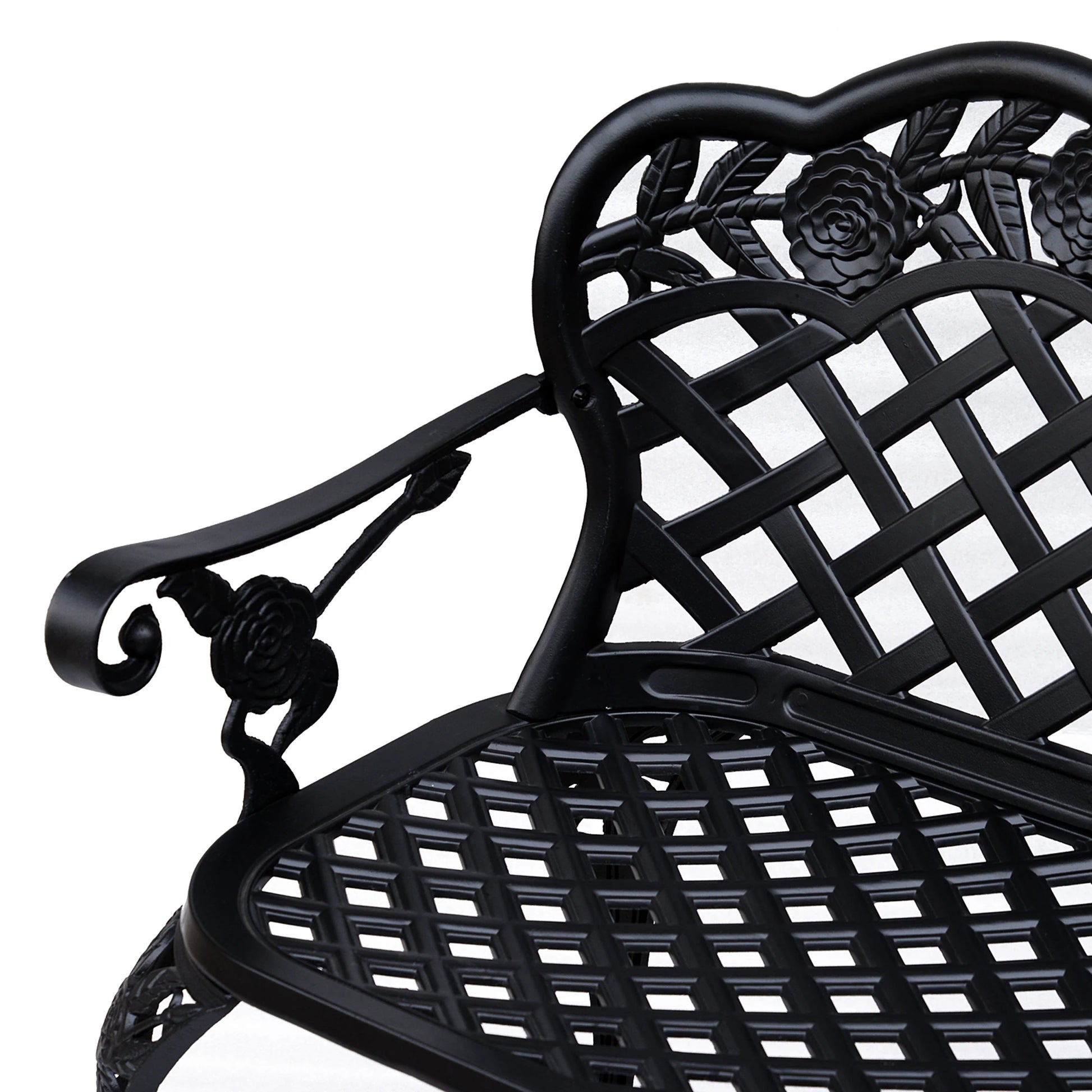 Close-up of a black metal chair with intricate designs on a white background