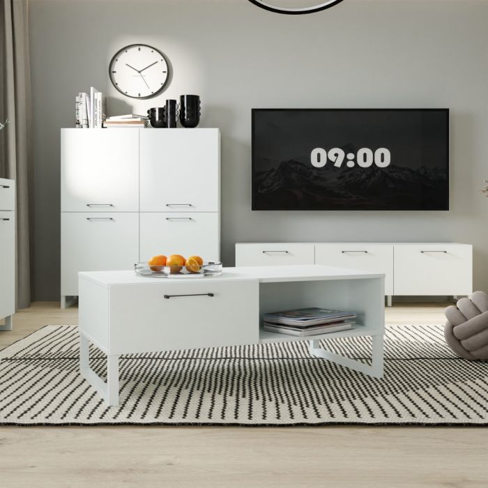 Modern living room with white furniture, including a coffee table and cabinets.