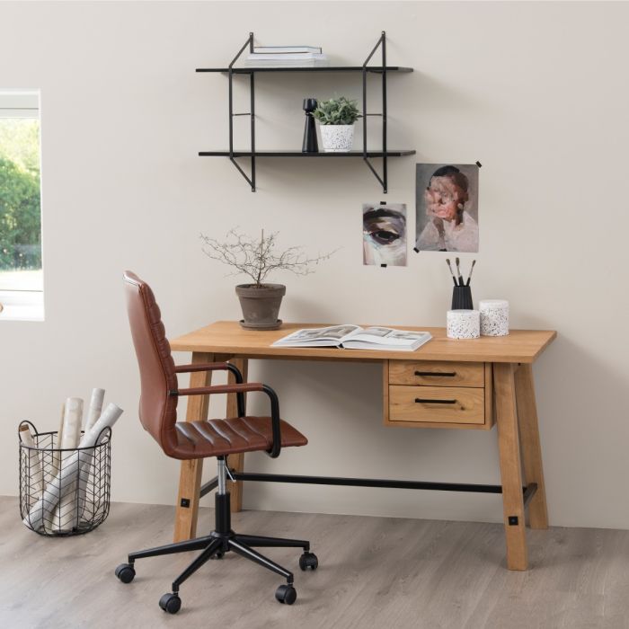 Home office setup with wooden desk, chair, and wall shelves.