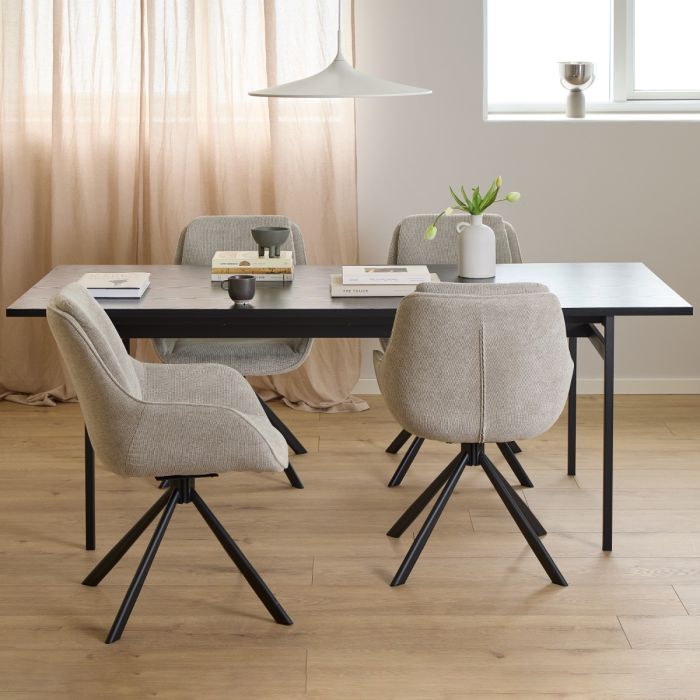 Dining room with a table and chairs in a modern interior setting.