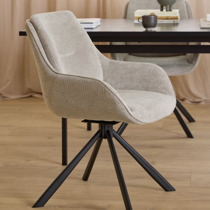Beige chair with black metal legs in a room setting
