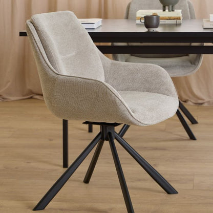 Beige chair with black metal legs in a room setting