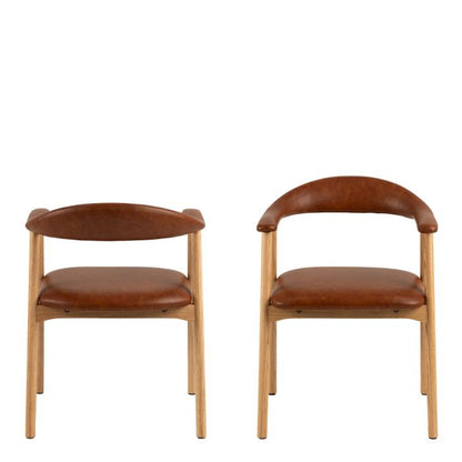 Two brown leather chairs with wooden frames on a white background