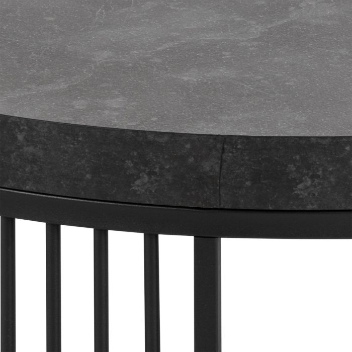 Round table with dark gray marble top and black metal base on a white background