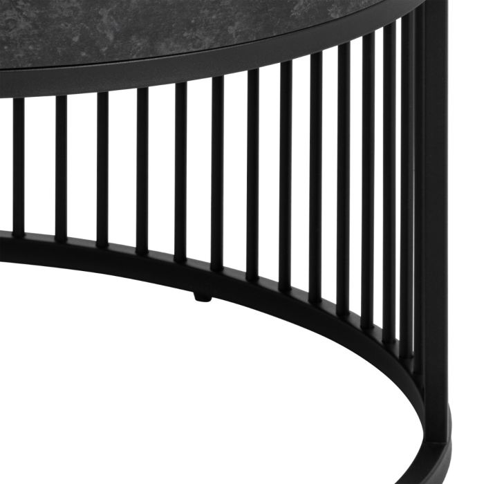 Black metal side table with a curved design on a white background