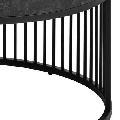 Black metal side table with a curved design on a white background