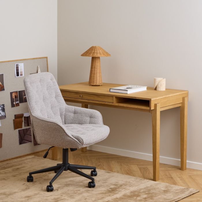 Wooden desk with chair and lamp in a home office setting