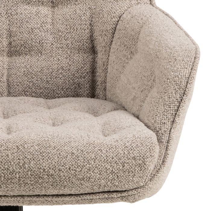 Close-up of a textured beige sofa armrest on a white background
