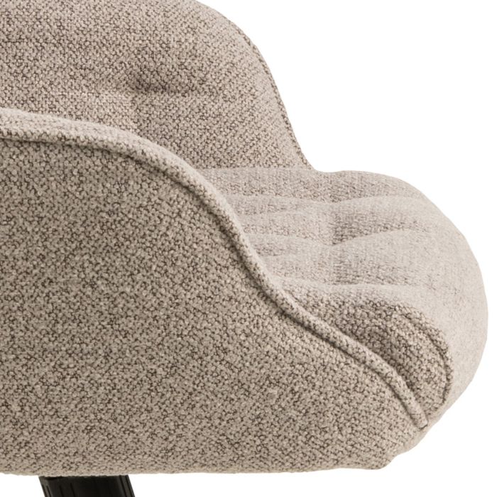 Close-up of a textured beige armchair on a white background