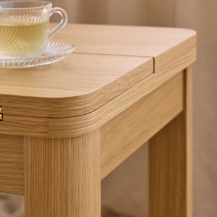 Wooden table with a cup and saucer on a neutral background