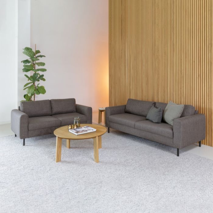 Modern living room with gray sofas, a wooden coffee table, and decorative items.