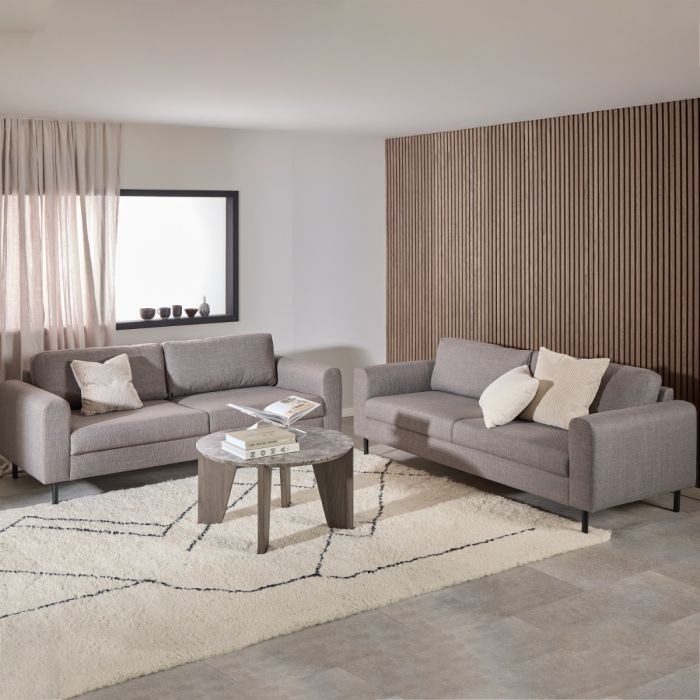 Modern living room with gray sofas, a coffee table, and decorative pillows.