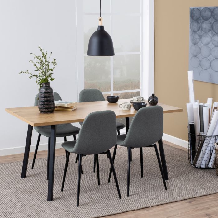 Dining room with wooden table and gray chairs, black pendant light, and decorative elements.