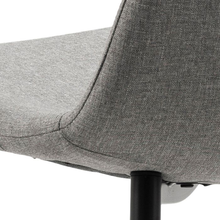 Gray upholstered chair with a black metal leg on a white background