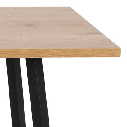Wooden table with black metal legs on a white background