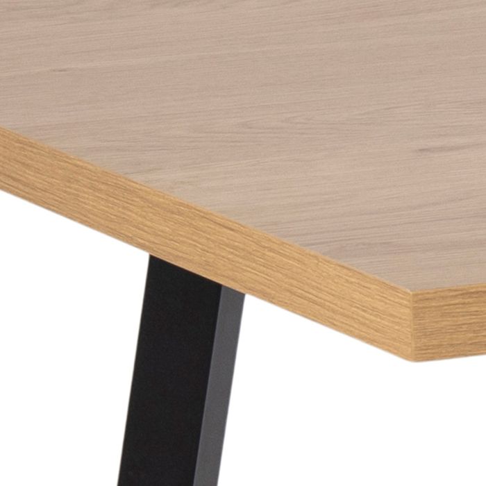 Wooden table with a black metal leg on a white background