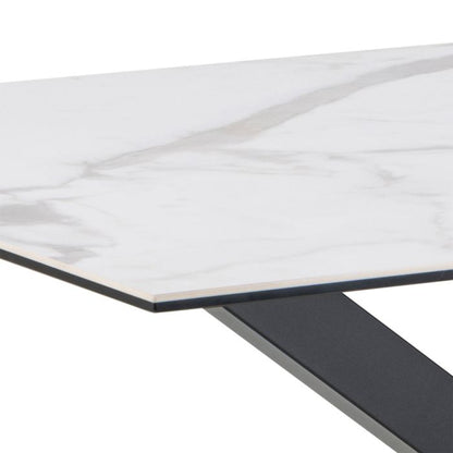 Close-up of a table with a white marble-like top and black metal legs on a white background