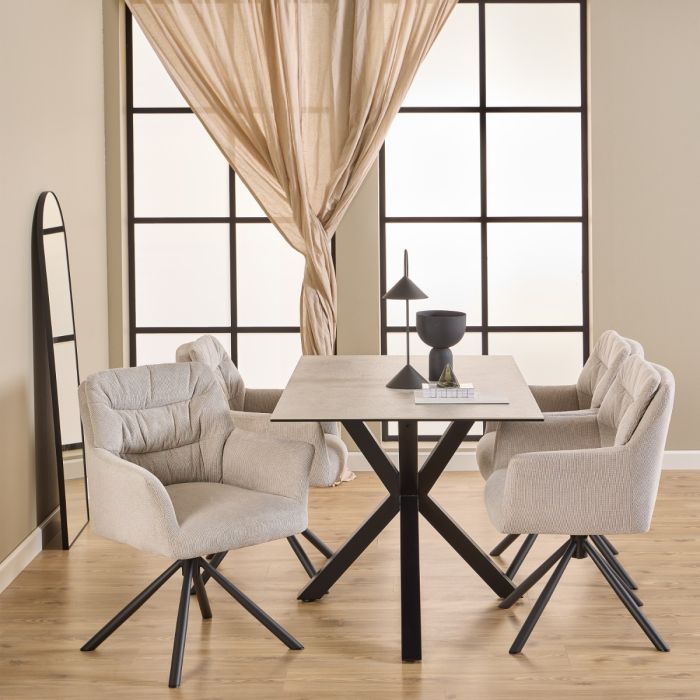 Dining room with a table and four chairs in a well-lit room.