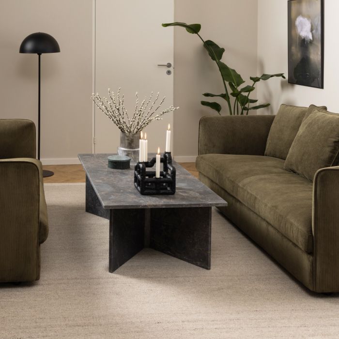 Modern living room with a gray coffee table, brown sofa, and decorative elements.