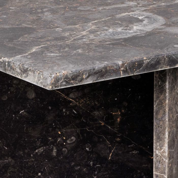 Close-up of a dark marble table with visible veins and texture.