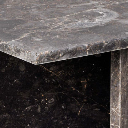 Close-up of a dark marble table with visible veins and texture.