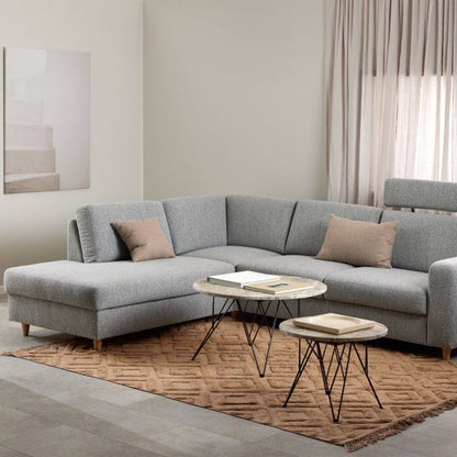 Gray sectional sofa in a living room with a coffee table and decorative items.