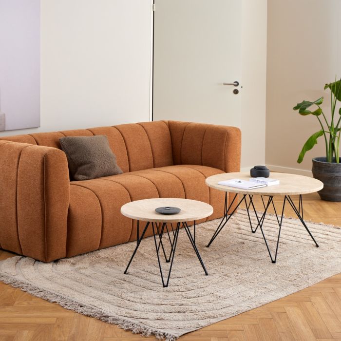Brown sectional sofa with two coffee tables in a living room setting.