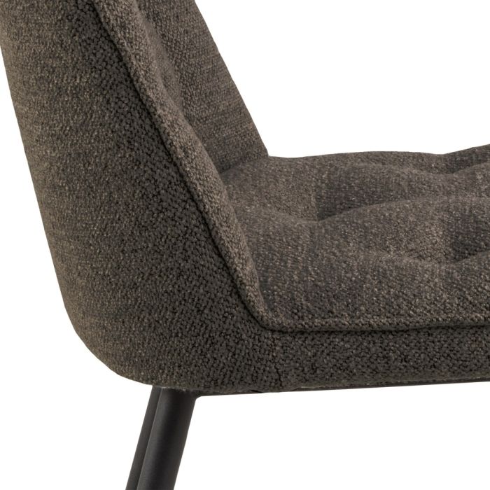 Close-up of a textured brown chair with a white background