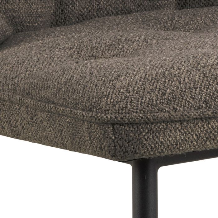 Close-up of a textured brown chair seat with a white background