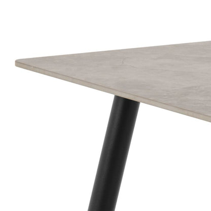 Table with a light gray surface and black metal leg on a white background