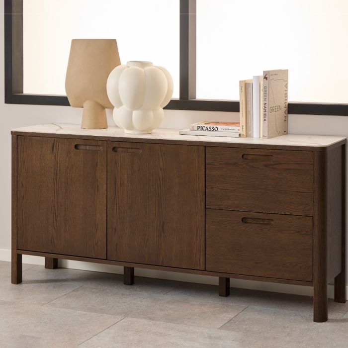 Wooden sideboard with decorative items against a neutral wall