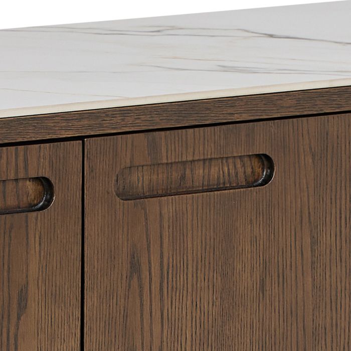 Close-up of a wooden cabinet with a white marble countertop.