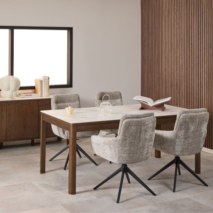 Dining room with a wooden table and gray chairs in a modern interior setting.