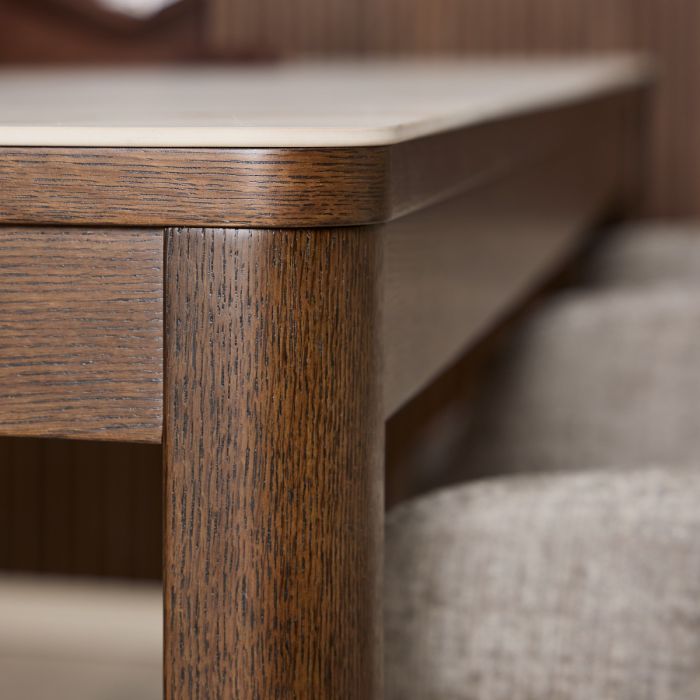 Close-up of a wooden table leg with a blurred background