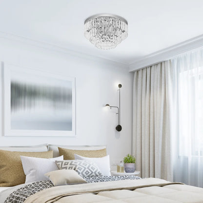 Modern bedroom with a chandelier, bed, and window treatments.