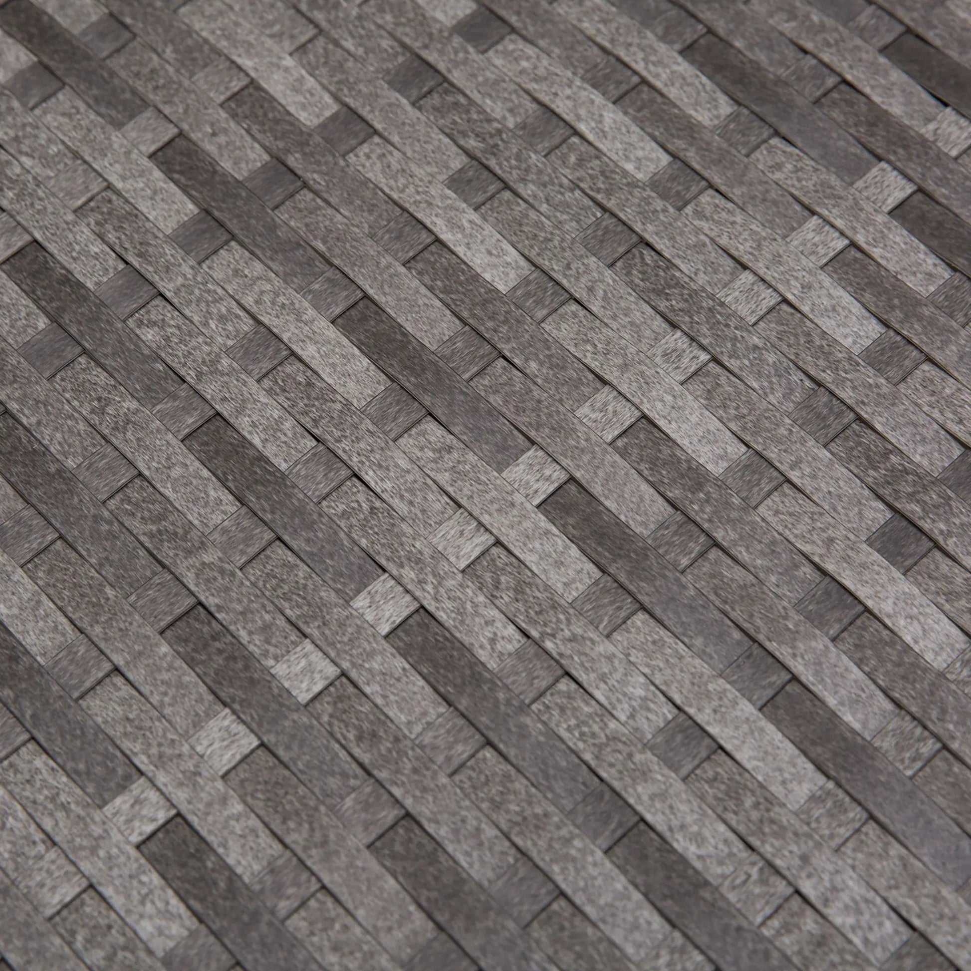 Patterned stone or tile surface with a herringbone design.