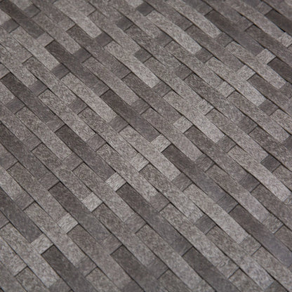 Patterned stone or tile surface with a herringbone design.