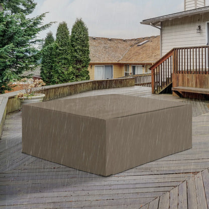 Brown rectangular outdoor furniture cover on a wooden deck with a house and trees in the background