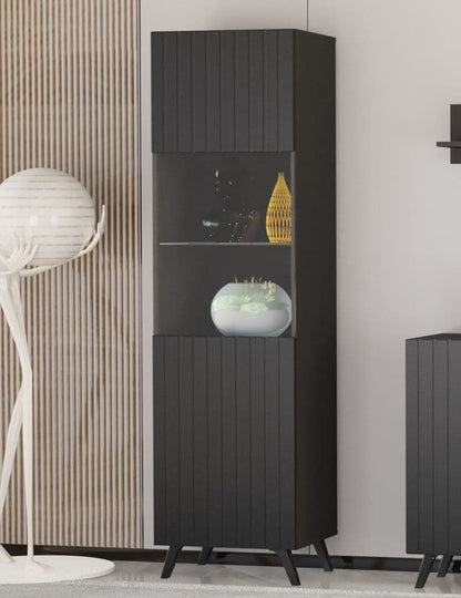 Tall black cabinet with decorative items in a modern interior setting