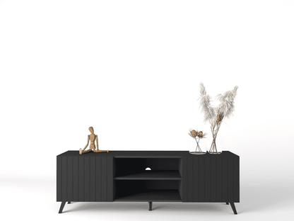 Black entertainment console with decorative items on a white background