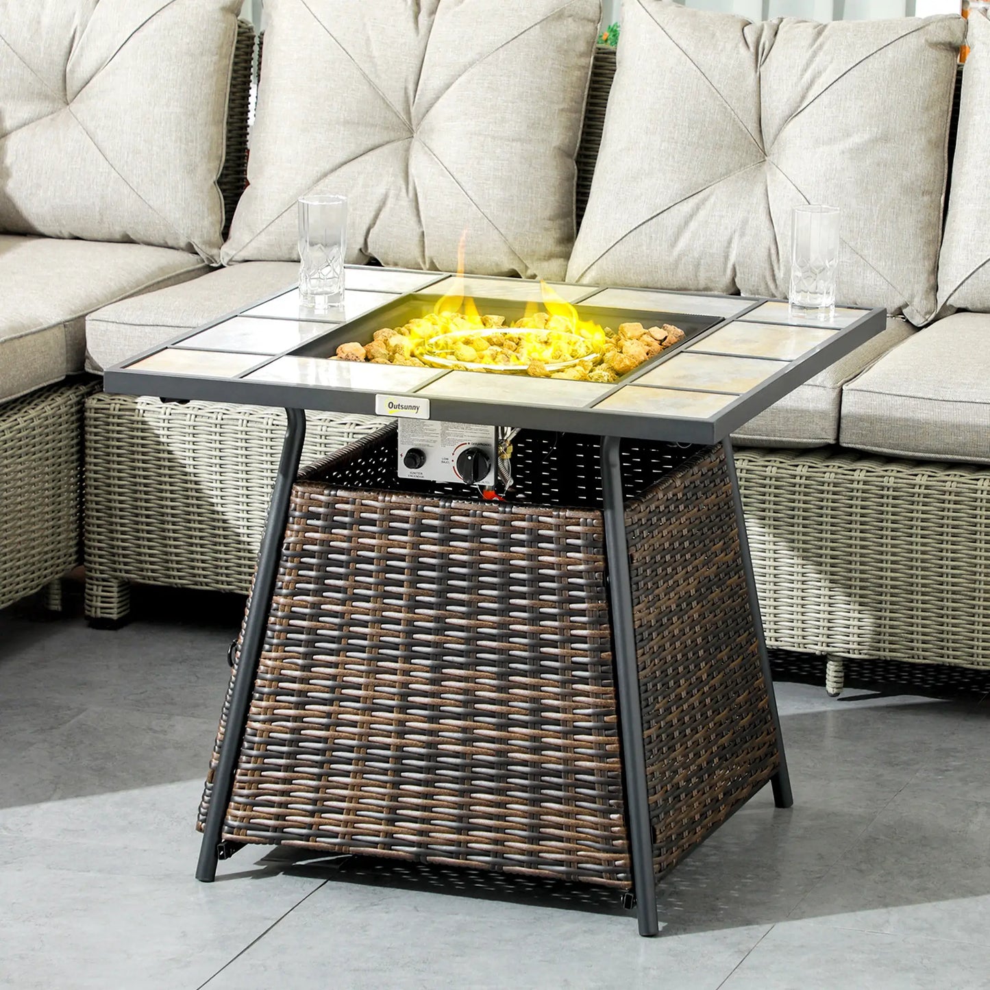 Outdoor patio table with fire pit feature in a garden setting