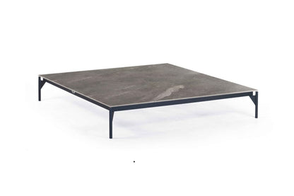 Hexagonal table with a dark gray surface and black metal legs on a white background