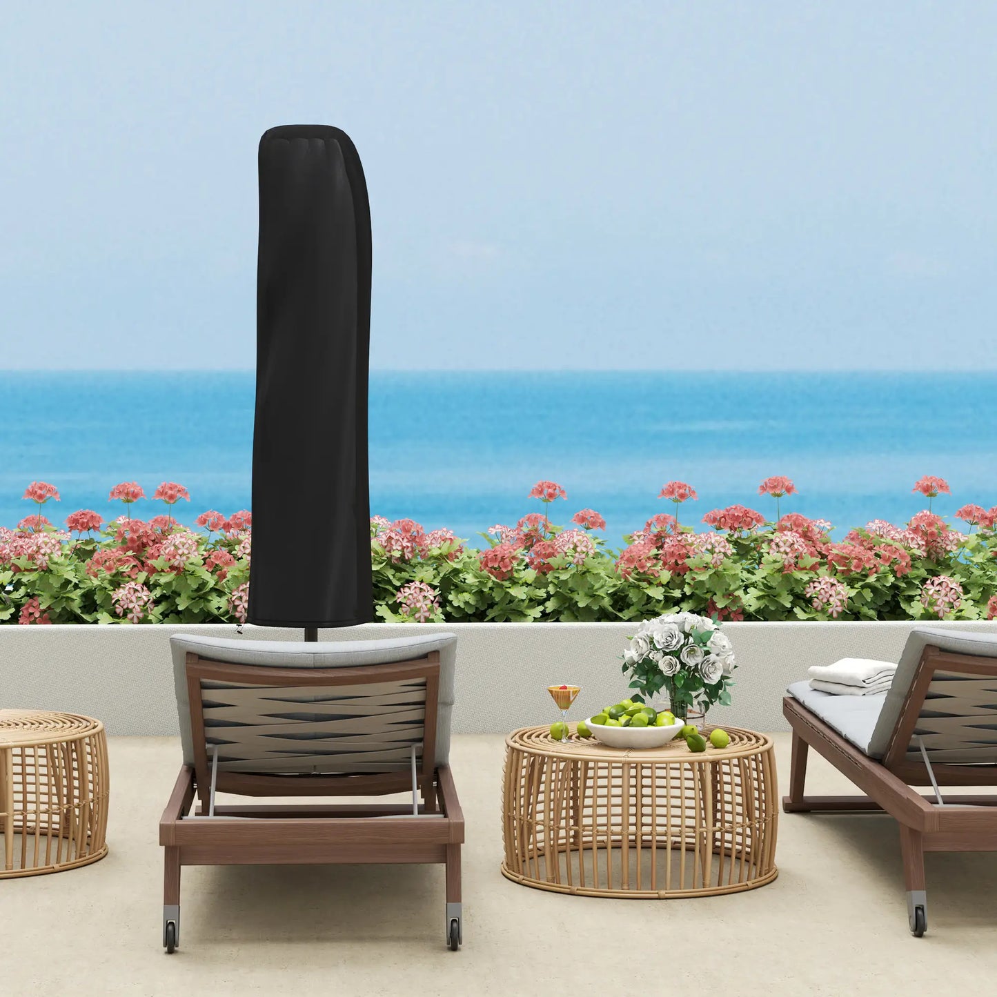 Outdoor patio set with chairs, table, and umbrella cover against a scenic ocean backdrop.