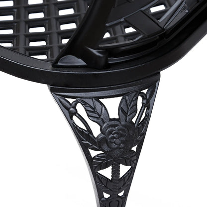 Close-up of a black metal decorative shelf bracket with intricate designs on a white background