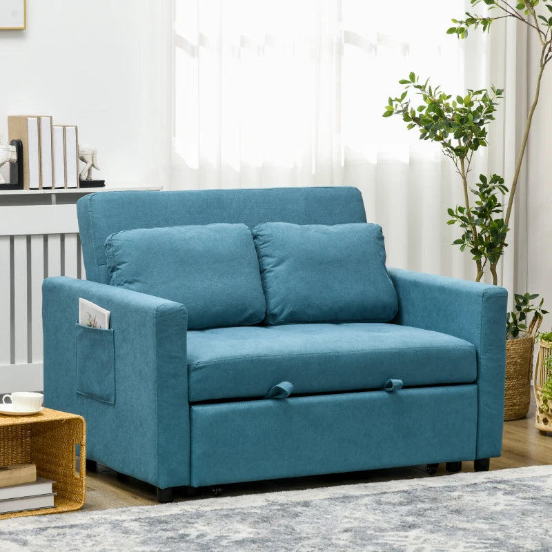 Blue sofa in a living room setting with plants and books.