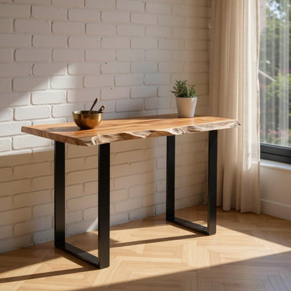 Wooden table with black metal legs in a room with a brick wall and window.