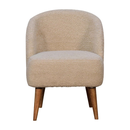 Beige upholstered chair with wooden legs on a white background