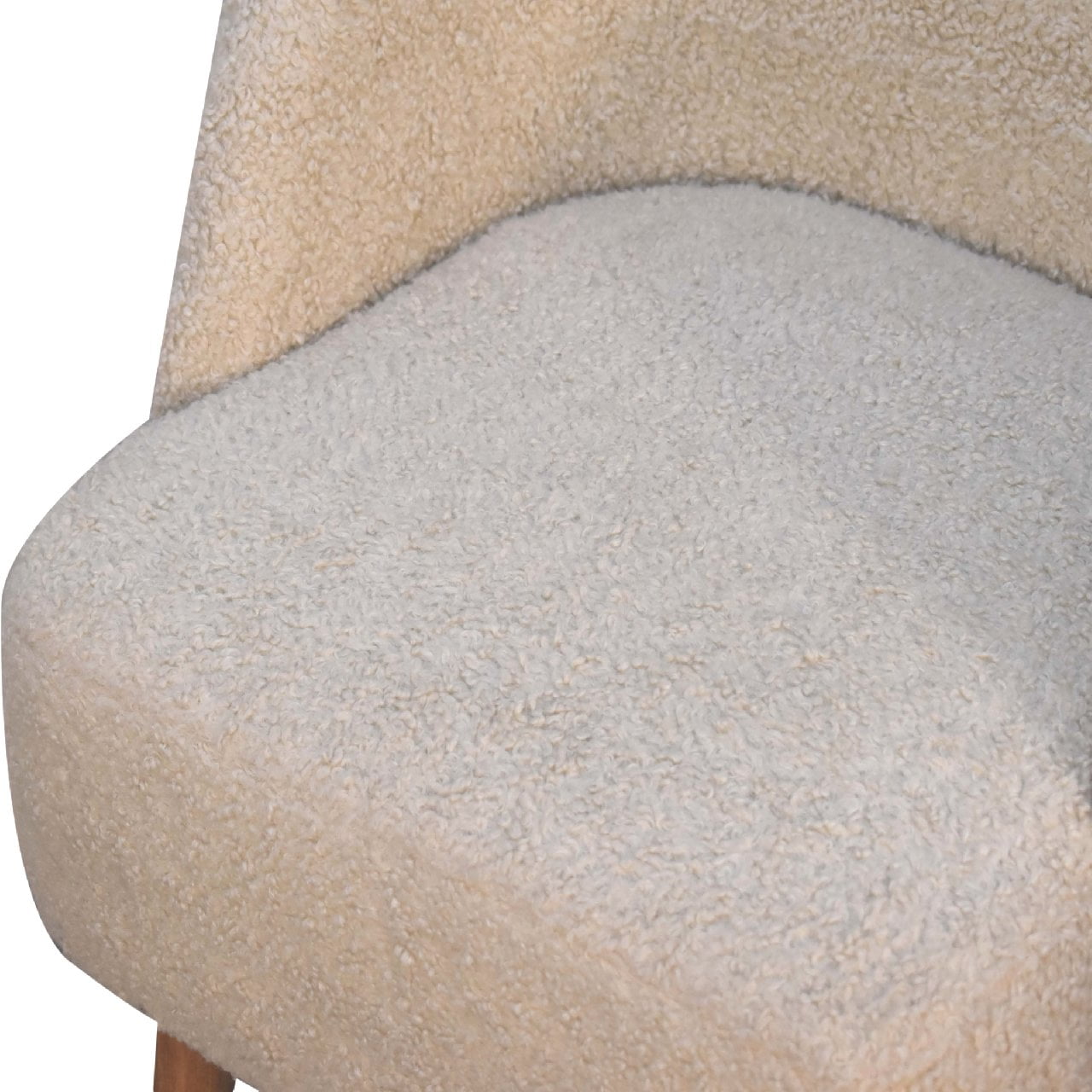 Close-up of a textured chair seat with a neutral color scheme.