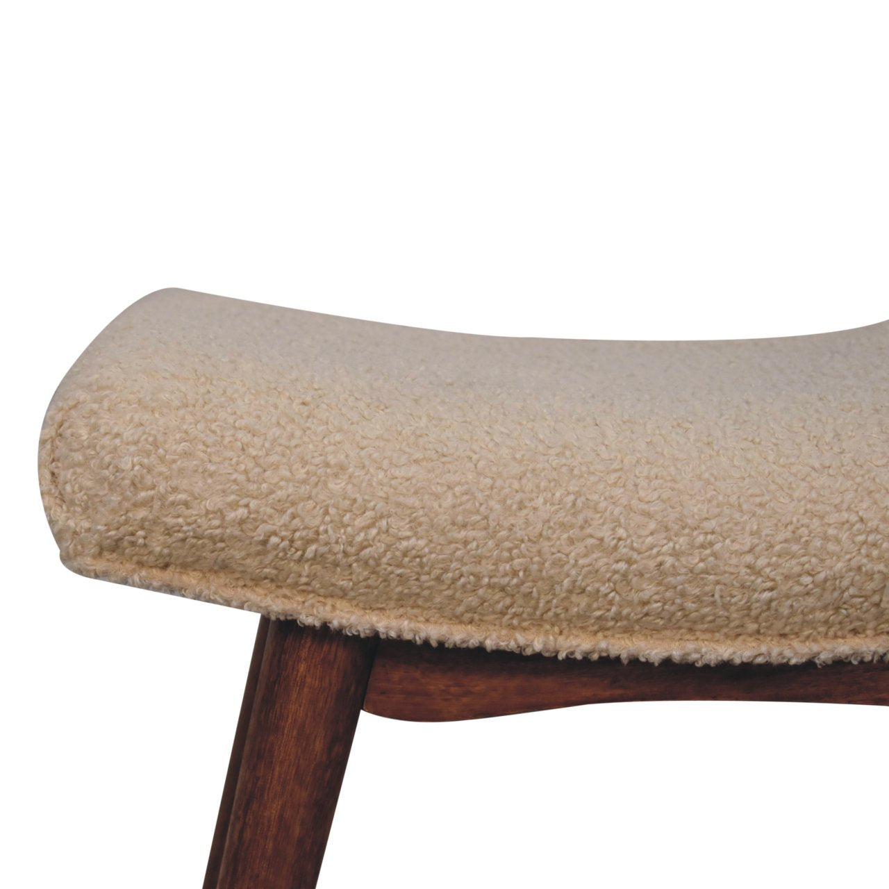 Close-up of a cushioned stool with wooden legs on a white background