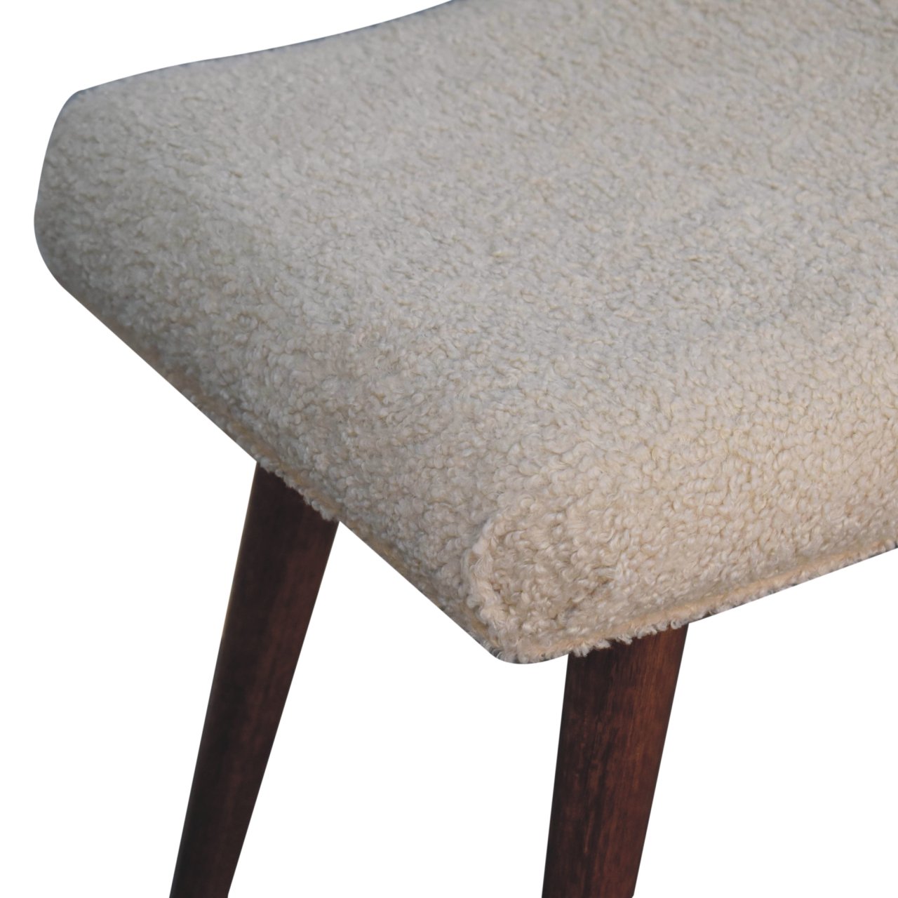 Close-up of a textured stool with wooden legs on a white background